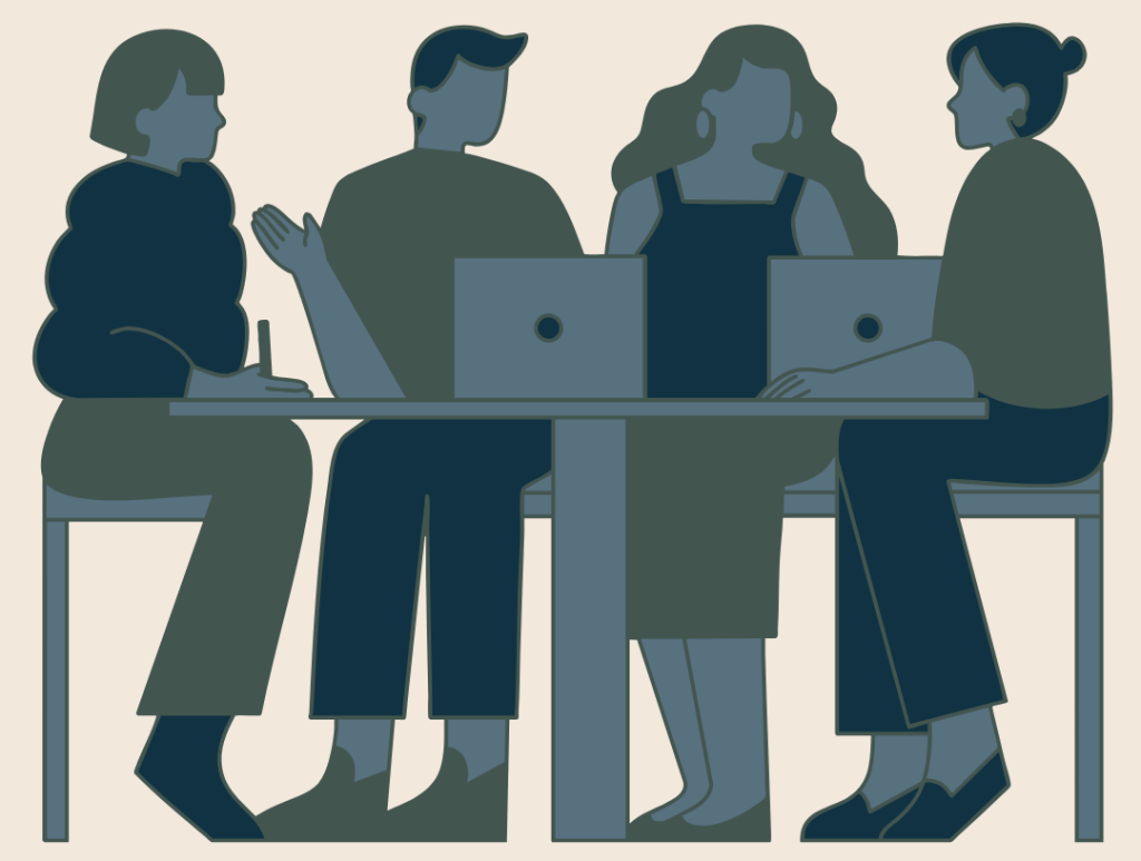 people at a table with laptops