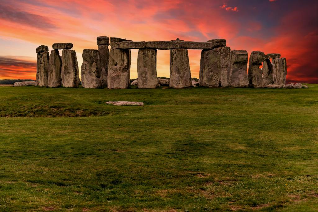 Stonehenge on the Salisbury Plain, England, near sunset under a sky on fire